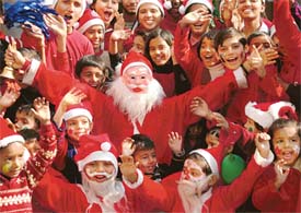 Children enjoy with Santa Claus at Sanjay Public Senior Secondary School, Sector 44, Chandigarh, on Thursday. 
