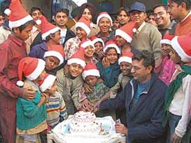 Members of the Guru Leela Smajik Inqlab Sanstha celebrate Christmas with slum kids in Ludhiana on Thursday. 