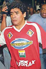 Former football legend  Diego Maradona  of Argentina enters the playing field to play in a charitable friendly match on Wednesday in Rio de Janeiro (Brazil). Maradona was detained by the police at Rio de Janeiro's airport due to an incident after missing his flight to Buenos Aires.