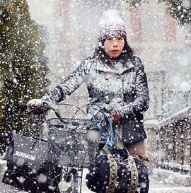 A woman walks as snow falls in Osaka