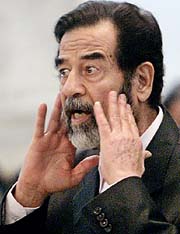 Former Iraqi President Saddam Hussein speaks at his trial in Baghdad