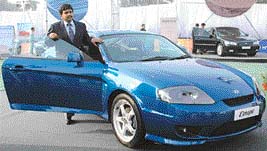 Mr N. Raja poses with the sports coupe, Tuscani, to be launched in India next year, during a roadshow at Chandigarh on Friday