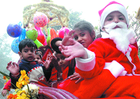 A child dressed as Santa Claus participates in a Christmas procession in the Capital on Friday.