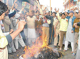 Activists of the Majlis Ahra burn an effigy of the Ahmediya leader Mirza Masroor outside the Jama Masjid in Ludhiana on Friday.