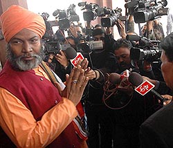 Member of Parliament Sakshi Maharaj, who was involved in the MPLAD scam, is surrounded by mediapersons as he comes out of Parliament House on Friday. 