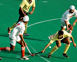 A Punjab and Sind Bank player tries to thwart a move by Namdhari XI players in the final of the SN Vohras 35th All-India Gurmit Memorial Hockey Tournament in Chandigarh on Saturday