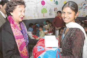 SHE SANTAA little girl smiles bright as she receives her Christmas gift from her she Santa the first Lady Ms Jean Rodrigues, at a ceremony organised by the Durga Das Foundation at Indira Colony, Manimajra