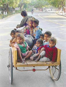 A boy tries to give a ride to children huddled in a rehri in Phase IX, Mohali