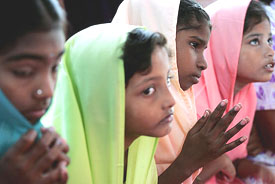 Tsunami survivors pray during a Christmas mass at a church in the fishing village of Akkarapettai in Nagapattinam, about 325 km from Chennai, on Sunday. 