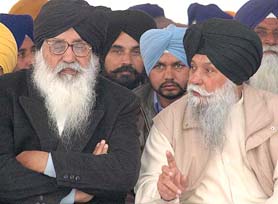 Shiromani Akali Dal president Parkash Singh Badal discusses a point with Capt Kanwaljit Singh during the Shaheedi Jor Mela political conference at Fatehgarh Sahib on Sunday. 