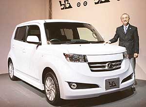 Toyota Motor Corp President Katsuaki Watanabe smiles as he introduces fully remodelled version of bB compact vehicle during a press conference in Tokyo on Monday