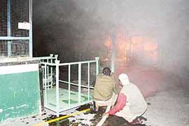 Firemen struggle to extinguish a fire, which broke out on the premises of the Anand Nishikawa, near Lalru, on Monday.