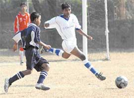 Players vie for the ball during the Orissa-Tripura match in the ongoing National Under-14 Soccer Festival in Chandigarh on Monday.