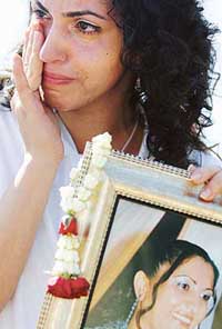 Israeli Nushin Shabo cries as she holds a picture of her monther, Hemda Cohen, who died in the tsunami, during a memorial ceremony marking the one year anniversary of the Indian Ocean tsunami on Thailand's island of Phi Phi on Monday. 