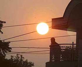 A Ludhiana resident stands in the balcony of his house in an attempt to feel the warmth of the sun till the last minute before it sets in the west.