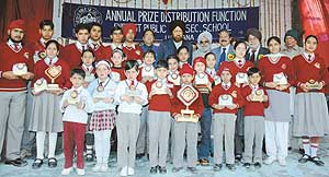 Students pose for a photograph after receiving awards at the annual prize distribution function of Everest school in Ludhiana on Monday.