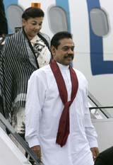 Sri Lankan President Mahinda Rajapaksa and his wife disembark from a plane on their arrival in New Delhi on Tuesday