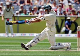 Australias Michael Hussey hits a boundary on his way to scoring a century during the first innings of the second Test against South Africa in Melbourne on Tuesday