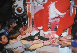 Santa Claus distributes toothpastes to kids on Christmas. 
