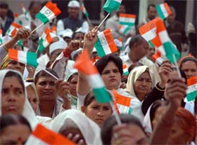 Women workers wave party flag during the Congress foundation day celebrations by the Haryana Pradesh Congress Seva Dal, at Haryana Bhavan in New Delhi