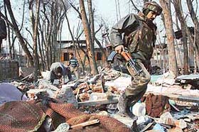 The bodies of three militants laid out near a destroyed house where they were killed by the security forces at Khrew village in Pulwama district