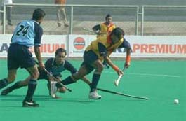 An EME player tries to get past RCFs full-back during the opening match of the Surjit Memorial Hockey Tournament in Jalandhar