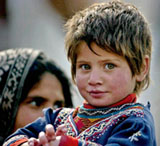 A Pakistani Kashmiri girl stands outside her temporary home in Muzaffarabad on Friday. Pakistans economic growth is likely to slow down from 8.4 per cent in 2004-05 to between 6 and 6.6 per cent during the currect fiscal year, below the governments target of 7 per cent. 