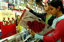 Customers look at greeting cards at a gift shop on New Year eve in Chandigarh on Saturday