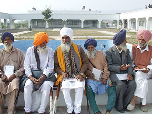 Inmates of the Multipurpose Old-Age Care Home at Badal village in Bathinda district interact with each other on Friday.