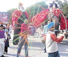 Devotees display their skills during a procession to mark the birth anniversary of Guru Gobind Singh in Mohali on Monday.