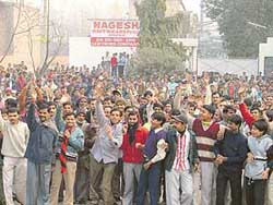 Workers of Nagesh Knitwear protest in front of the factory in Ludhiana on Monday. 
