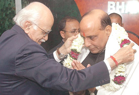 Mr L.K. Advani welcomes newly appointed BJP chief Rajnath Singh at the party headquarters in New Delhi on Monday