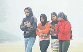 PU students walk back to their hostels on Tuesday afternoon after the city experienced first thick fog of the season