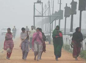 Women labourers on their way to work on a chilly morning in the Capital