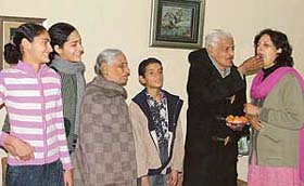 Ms Vijay Rai, wife of Mr Harish Dhanda, newly elected chairman of the Bar Council, Punjab and Haryana, being offered sweets by her father-in-law, Mr Kulbhushan Rai, in Ludhiana
