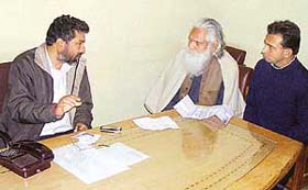 Mr Jatinder Bhola, president of the Ahmedgarh Municipal Council, listens to the grievances of a dependant of a freedom fighter