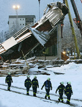 Firefighters walk near the collapsed roof of an ice skating rink in Bad Reichenhall, about 130 km south of Munich, on Tuesday. 