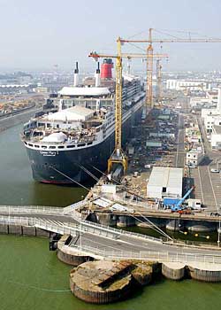 An aerial view of the worlds largest liner, Queen Mary II, is shown in a file photo of Chantiers de lAtlantique shipyard. French engineering conglomerate Alstom and Norwegian company Aker Yards on Wednesday announced plans to join forces in shipbuilding, with Aker Yards owning 75 per cent of the joint venture. Alstom and Aker Yards plan to create a new company, consisting of Alstom subsidiary Chantiers de lAtlantique shipyards in Saint-Nazaire and Lorient.