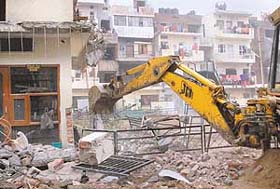 Illegal constructions in flats of Sector 45 being demolished by a demolition squad of the Chandigarh Housing Board in Chandigarh