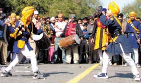 Sikh youths displaying their skills with arms during the Nagar Kirtan procession on the eve of the birth anniversary of Sri Guru Gobind Singh ji in the Capital