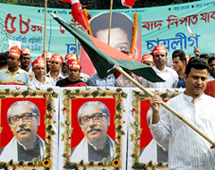 A leader of the Bangladesh Chhatra League, the student wing of Bangladeshs main Opposition Awami League Party, leads a march with a national flag as other students carry portraits of Sheikh Mujibur Rahaman, the independence leader of Bangladesh, during a celebration in Dhaka on Wednesday. The students were celebrating the 58th anniversary of the Chhatra league.