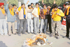 Members of the Hindu Sena burn an effigy of the CPM in Sector 17, Chandigarh. 
