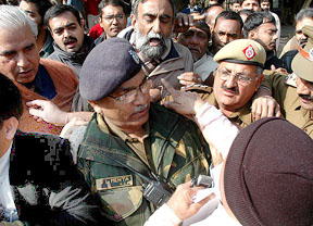 Delhi police officers try to control followers of Swami Ramdev and CPM leader Brinda Karat outside the CPM office in New Delhi on Thursday. The followers were protesting against Karat's allegation that animal parts and human bones were used in ayurvedic preparations manufactured at Ramdev's institution. 