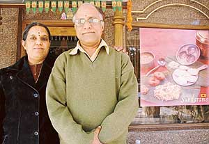 Uma Maheshwari and S. Sundaram pose outside their restaurant
