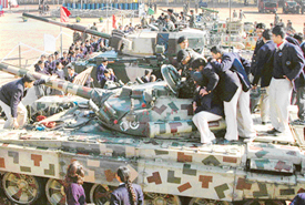 Students peer inside the turret of a T-72 tank during the "Know Your Army" exhibition in Chandigarh on Friday. 