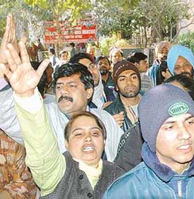 Supporters of CPM leader Brinda Karat shout slogans against Swami Ramdev on the issue of the alleged use of animal and human parts in ayurvedic medicines manufactured at Ramdev's institution in New Delhi on Friday. 