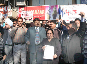 Deepa, wife of Pardeep Kinger, shows a copy of the complaint.