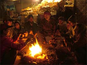 Fruit vendors outside the bus stand in Jalandhar seeking some solace from the bone-chilling cold on Saturday night