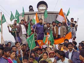 Activists of the Jharkhand Mukti Morcha block a railway track at Adityapur, near Jamshedpur, on Saturday