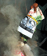 Activists of Loktantrik Samajwadi Party burning an effigy of Prime Minister Dr Manmohan Singh and Congress president Sonia Gandhi in protest against the cut in ration subsidy, in the Capital on Sunday.